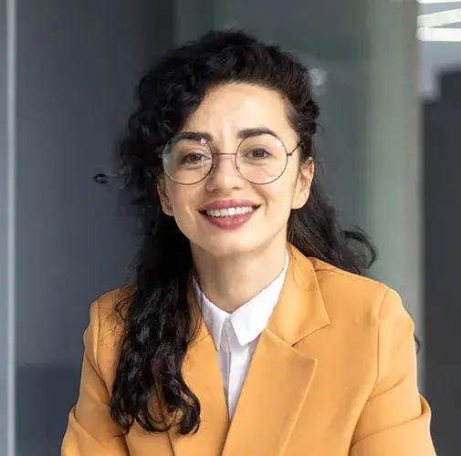 Woman in business attire smiling.